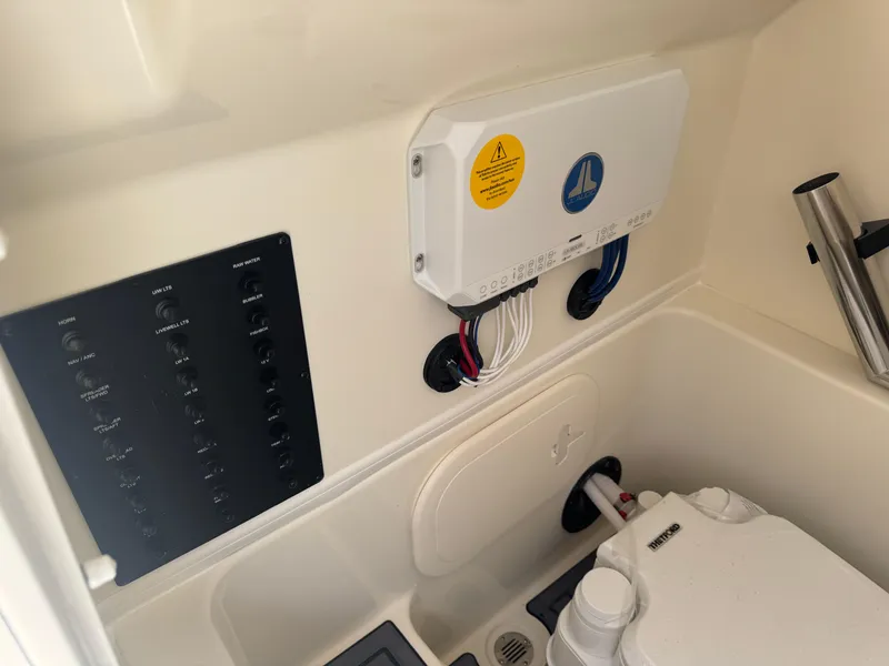 Slide: The Image of 2025 Pathfinder 2400 TRS boat interior with control panel and wiring. - 27