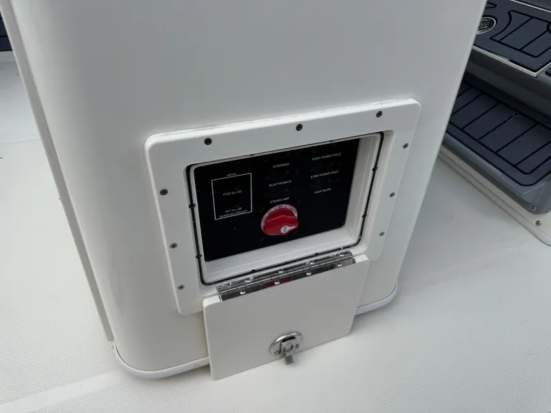 Slide: The Image of Control panel on 2025 Pathfinder 2400 TRS boat, featuring various switches and a red dial. - 43
