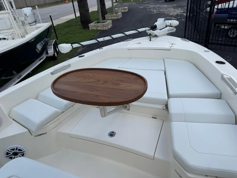 Slide: The Image of 2025 Pathfinder 2400 TRS boat interior with white seating and wooden table. - 45