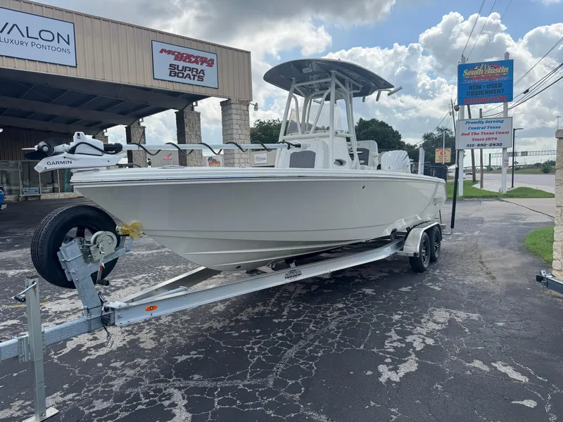 Slide: The Image of 2025 Pathfinder 2400 TRS boat on trailer outside dealership, featuring Garmin equipment. - 9