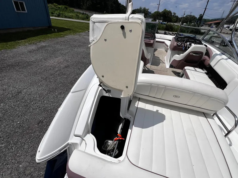 Slide: The Image of 2013 Cobalt 262 boat interior with open storage compartment and seating. - 13