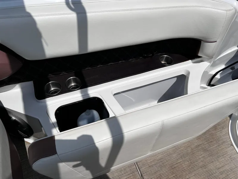 Slide: The Image of Interior of a 2013 Cobalt 262 boat featuring cup holders and storage compartments. - 15