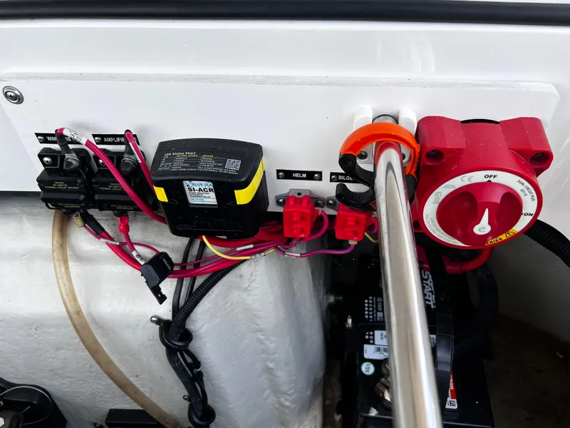 Slide: The Image of Electrical panel of a 2013 Cobalt 262 boat with wiring and switches. - 16