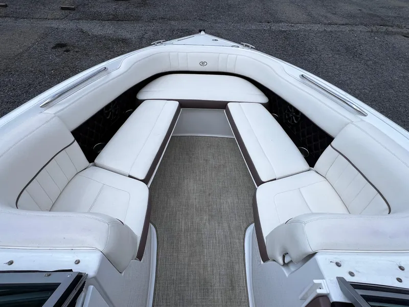 Slide: The Image of 2013 Cobalt 262 boat interior with white cushioned seating and carpeted floor. - 4