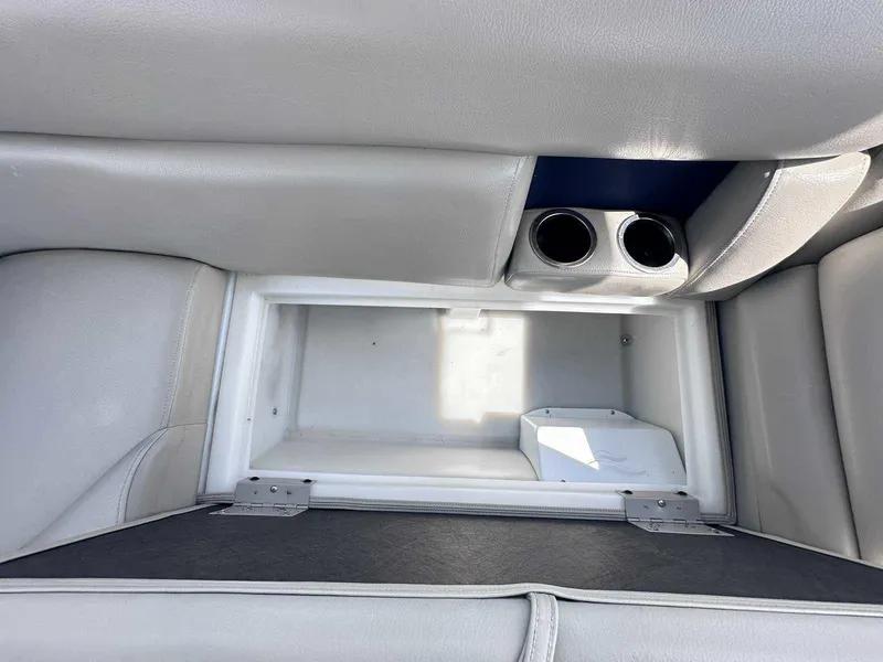 Slide: The Image of Interior storage compartment of 2022 Trifecta 22 CL E with cup holders. - 10