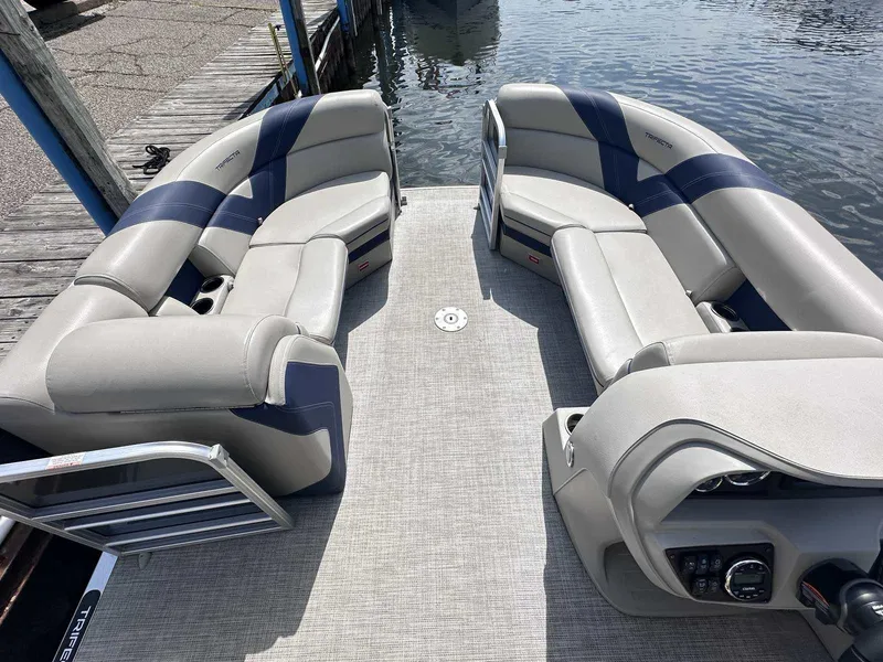 Slide: The Image of 2022 Trifecta 22 CL E pontoon boat interior with plush seating and modern controls. - 3