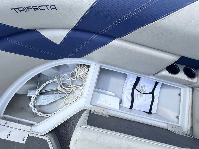 Slide: The Image of 2022 Trifecta 22 CL E boat storage compartment with anchor and rope. - 6