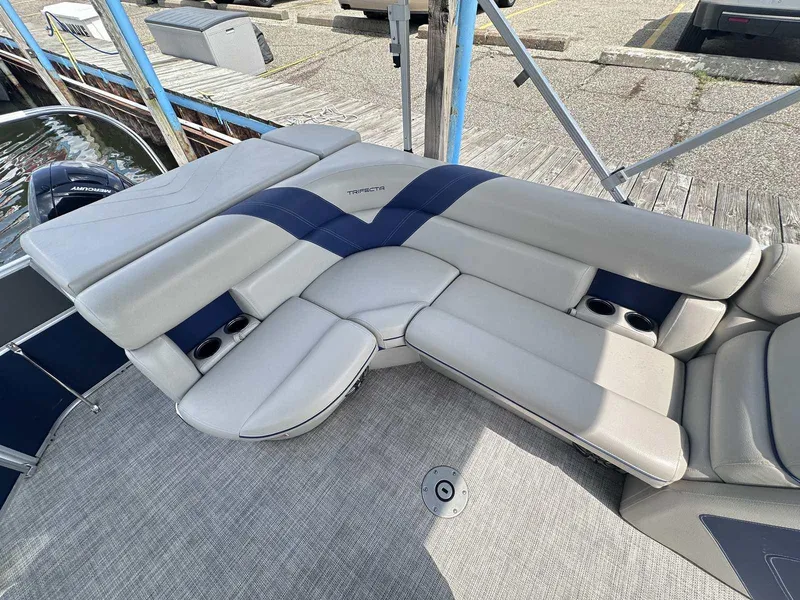 Slide: The Image of Luxurious seating on 2022 Trifecta 22 CL E pontoon boat, featuring cup holders and sleek design. - 9