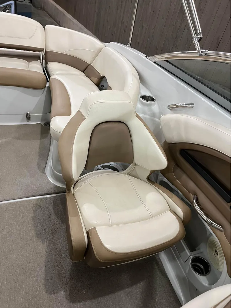 Slide: The Image of 2016 Crownline E-4 Bowrider interior with beige and white seating. - 10