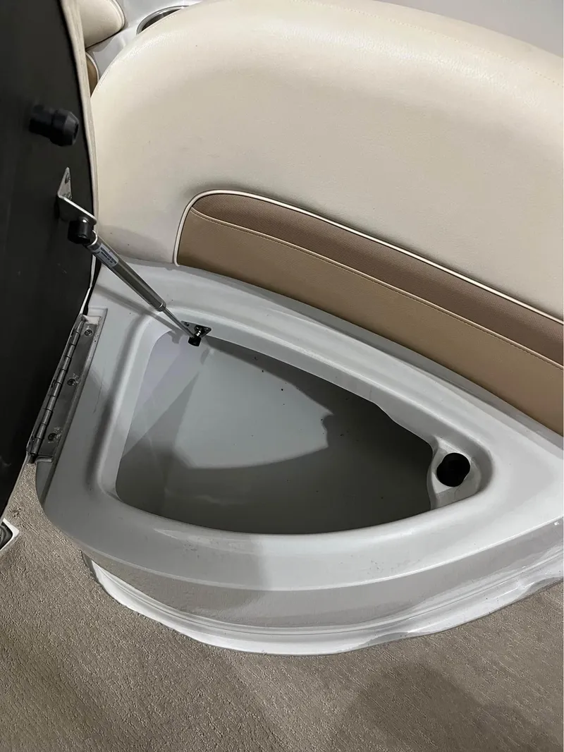 Slide: The Image of Open storage compartment in 2016 Crownline E-4 Bowrider boat, featuring beige seating. - 11