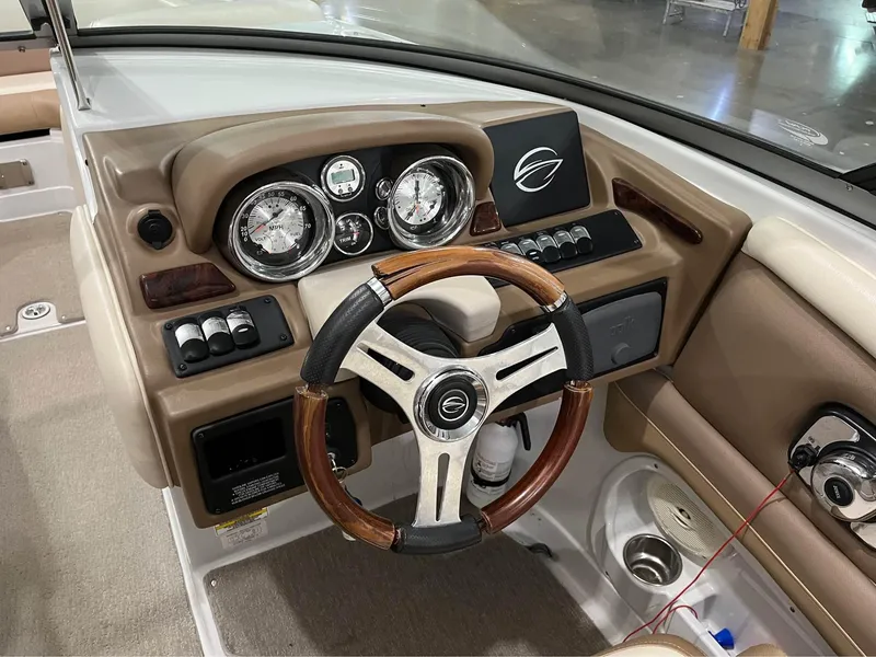 Slide: The Image of 2016 Crownline E-4 Bowrider dashboard with wood-accented steering wheel and instrument panel. - 12