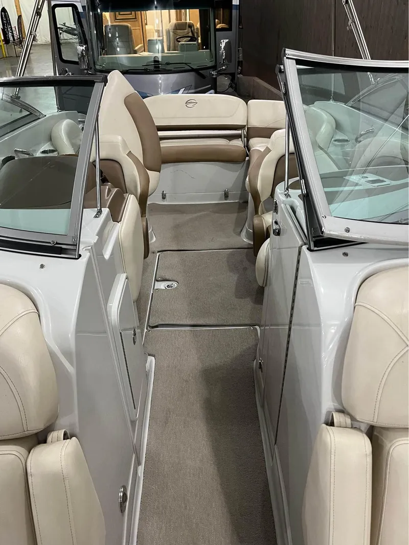 Slide: The Image of 2016 Crownline E-4 Bowrider interior with beige seating and spacious layout. - 4