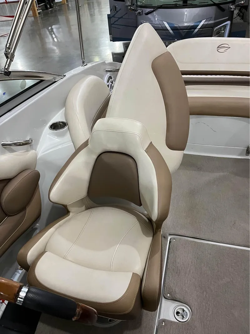 Slide: The Image of 2016 Crownline E-4 Bowrider interior with beige and brown seating. - 5