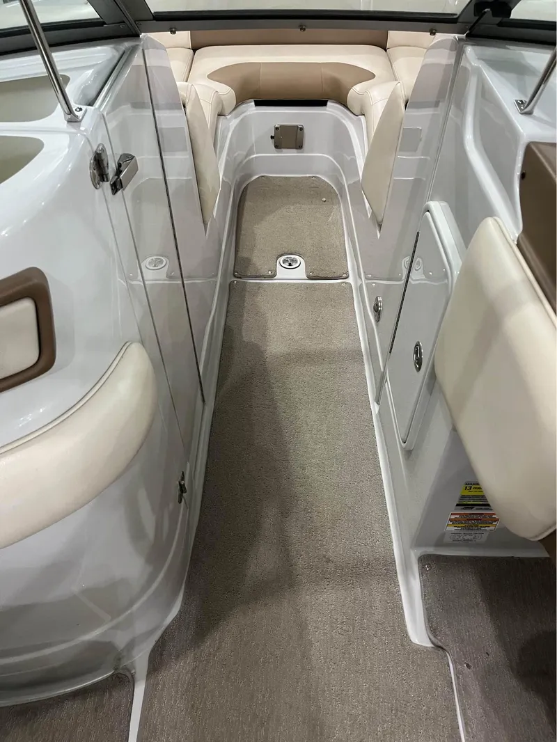 Slide: The Image of 2016 Crownline E-4 Bowrider interior with beige seating and carpeted flooring. - 6