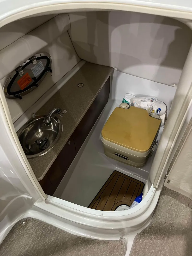 Slide: The Image of 2016 Crownline E-4 Bowrider interior with sink and portable toilet. - 7