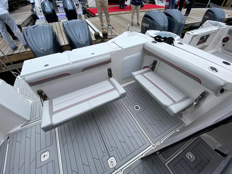 Slide: The Image of 2025 Solara S-310 CW boat interior with foldable seats and Yamaha engines at a dock. - 12