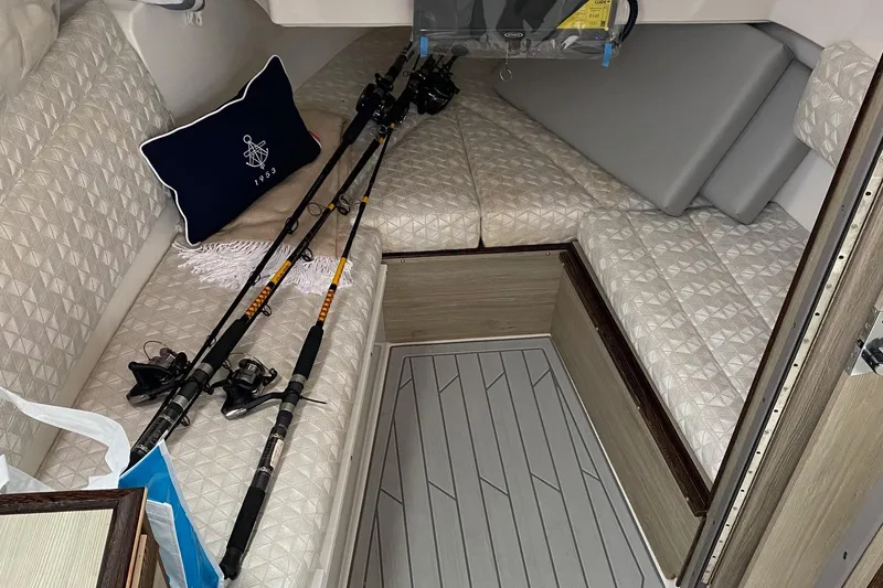 Slide: The Image of Interior of 2025 Solara S-310 CW boat with fishing rods and nautical decor. - 13