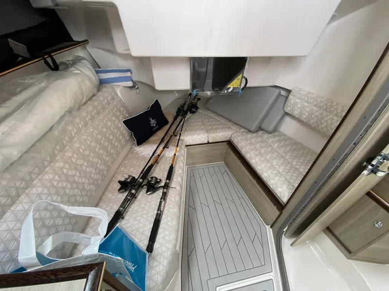 Slide: The Image of Interior of 2025 Solara S-310 CW boat with fishing rods and seating area. - 14