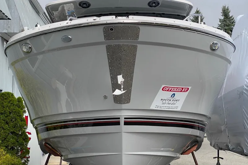 Slide: The Image of Front view of 2025 Solara S-310 CW boat, displayed outdoors. - 2