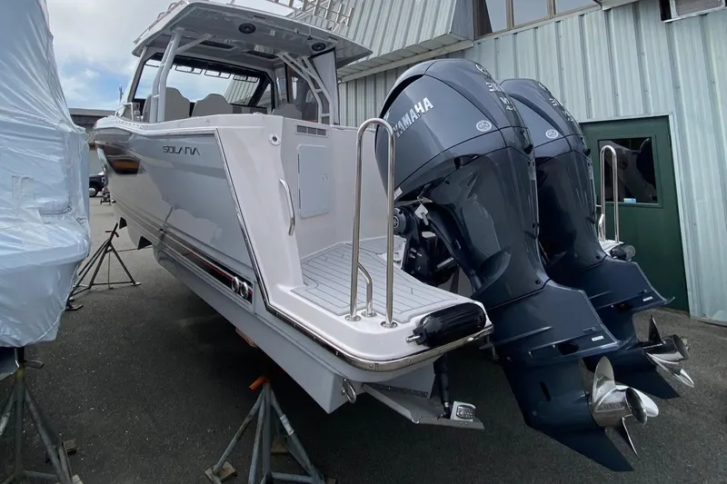 Slide: The Image of 2025 Solara S-310 CW boat with dual Yamaha outboard engines, docked outdoors. - 4
