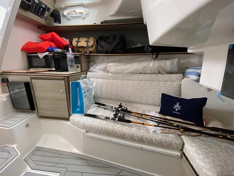 Slide: The Image of Interior of 2025 Solara S-310 CW boat with fishing rods and nautical decor. - 7