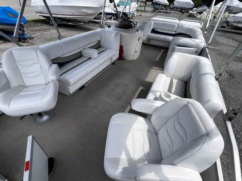 Slide: The Image of 2006 Crest II pontoon boat with white seating and spacious interior layout. - 4