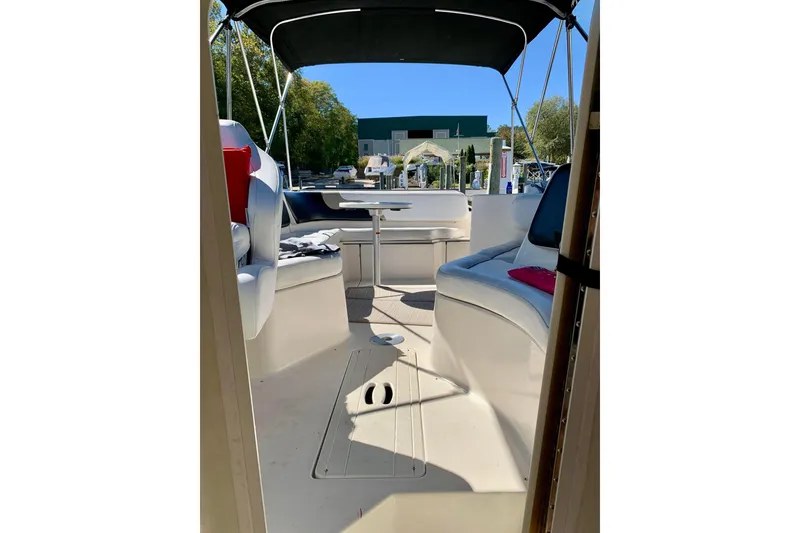 Slide: The Image of 2000 Rinker 272 Captiva Cuddy interior with seating and table under canopy. - 16