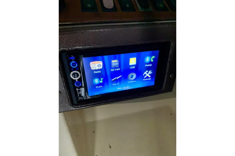 Slide: The Image of Touchscreen control panel on 2000 Rinker 272 Captiva Cuddy boat dashboard. - 17