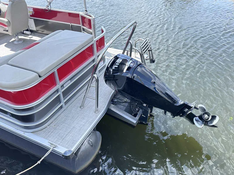 Slide: The Image of 2023 Trifecta 22 CLE 275 pontoon boat with outboard motor on water. - 14