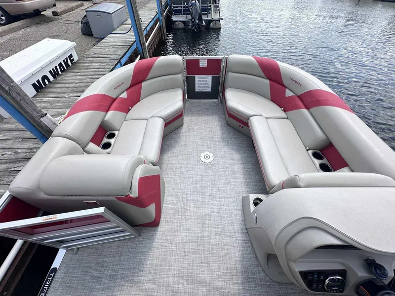 Slide: The Image of 2023 Trifecta 22 CLE 275 pontoon boat with red and gray seating at a dock. - 3