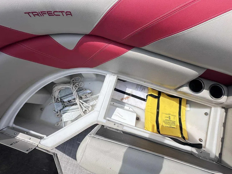 Slide: The Image of 2023 Trifecta 22 CLE 275 boat storage compartment with ropes and a yellow life jacket. - 4