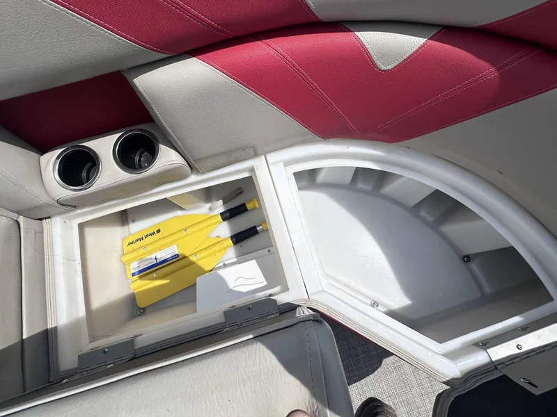 Slide: The Image of Storage compartment in 2023 Trifecta 22 CLE 275 boat with cup holders and safety equipment. - 5