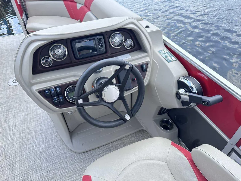 Slide: The Image of 2023 Trifecta 22 CLE 275 boat dashboard with steering wheel and controls. - 8