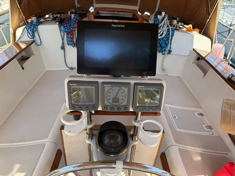 Slide: The Image of Cockpit of 1987 Island Packet 38 sailboat with navigation instruments and steering wheel. - 13
