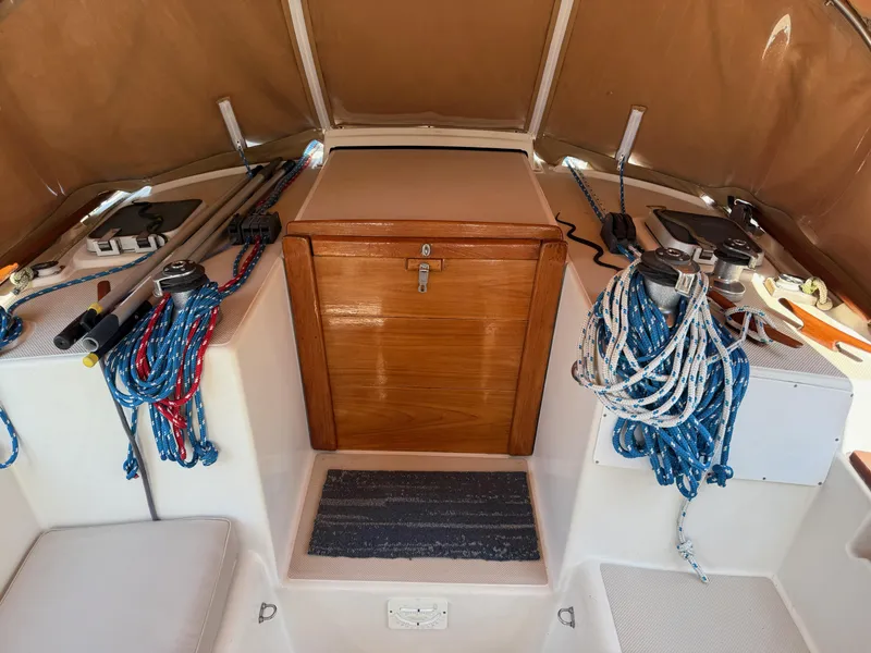 Slide: The Image of 1987 Island Packet 38 sailboat cockpit with ropes and wooden hatch. - 17