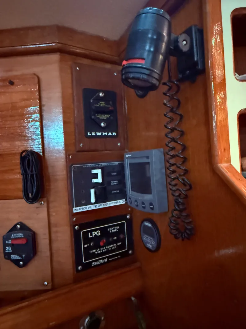 Slide: The Image of Control panel of a 1987 Island Packet 38 sailboat with various instruments and switches. - 27