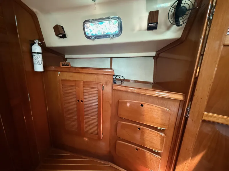 Slide: The Image of 1987 Island Packet 38 interior with wooden cabinetry and storage drawers. - 36