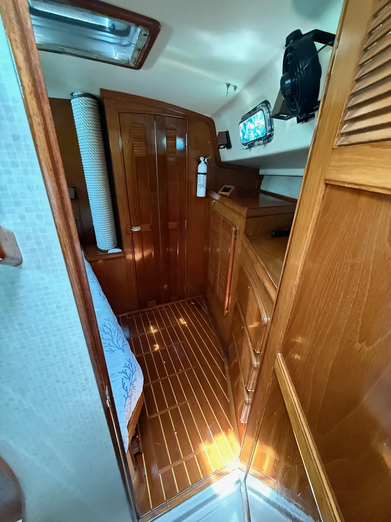 Slide: The Image of Interior of 1987 Island Packet 38 sailboat with wooden cabinetry and flooring. - 37