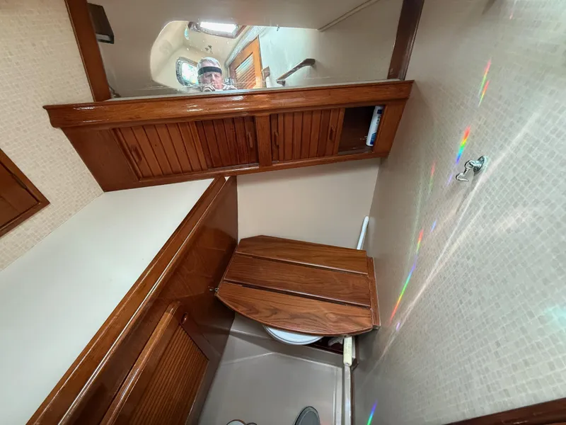 Slide: The Image of 1987 Island Packet 38 yacht bathroom with wooden cabinetry and compact design. - 43