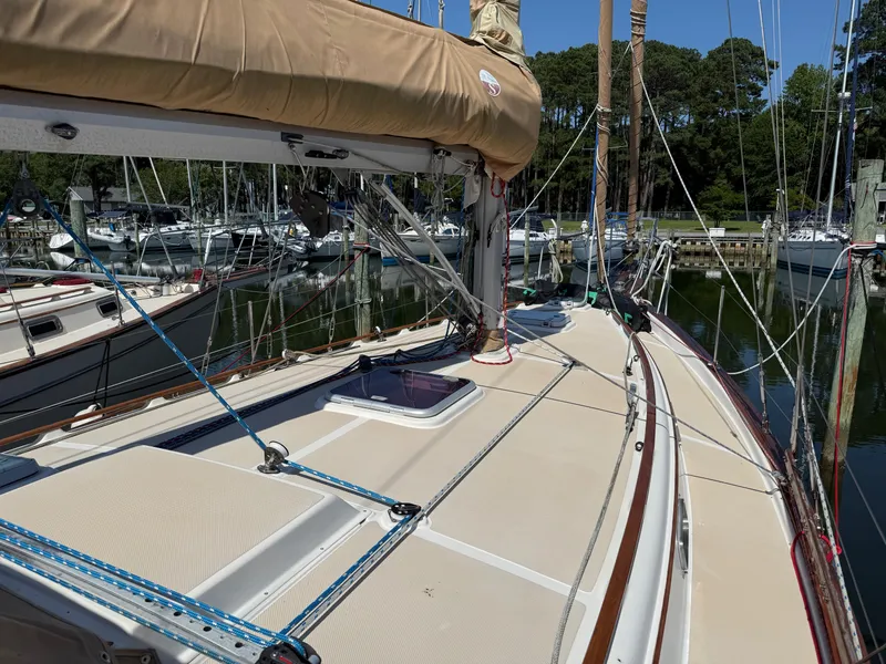 Slide: The Image of 1987 Island Packet 38 sailboat deck with rigging in marina setting. - 9