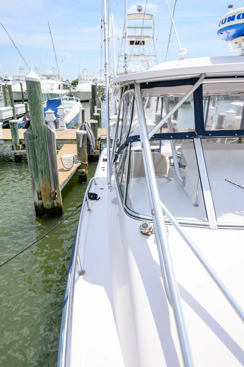 Slide: The Image of 2003 Grady-White Express 330 boat docked at marina, side view. - 24