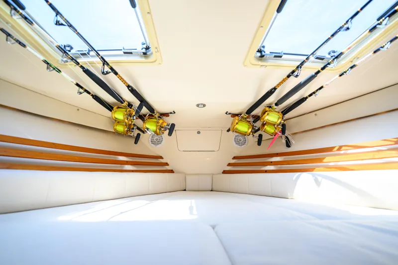 Slide: The Image of Interior of 2003 Grady-White Express 330 boat with fishing rods stored overhead. - 16