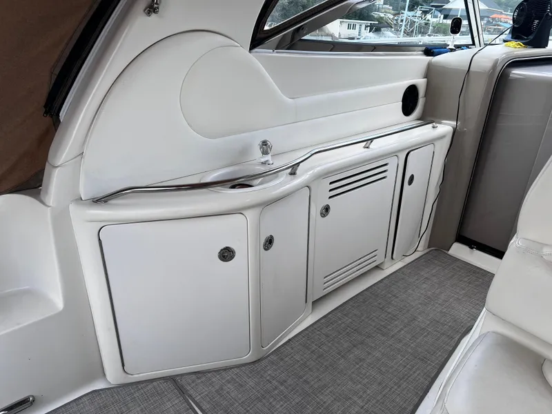 Slide: The Image of Interior of a 2000 Sea Ray 380 Sundancer boat, featuring sleek white cabinetry. - 10