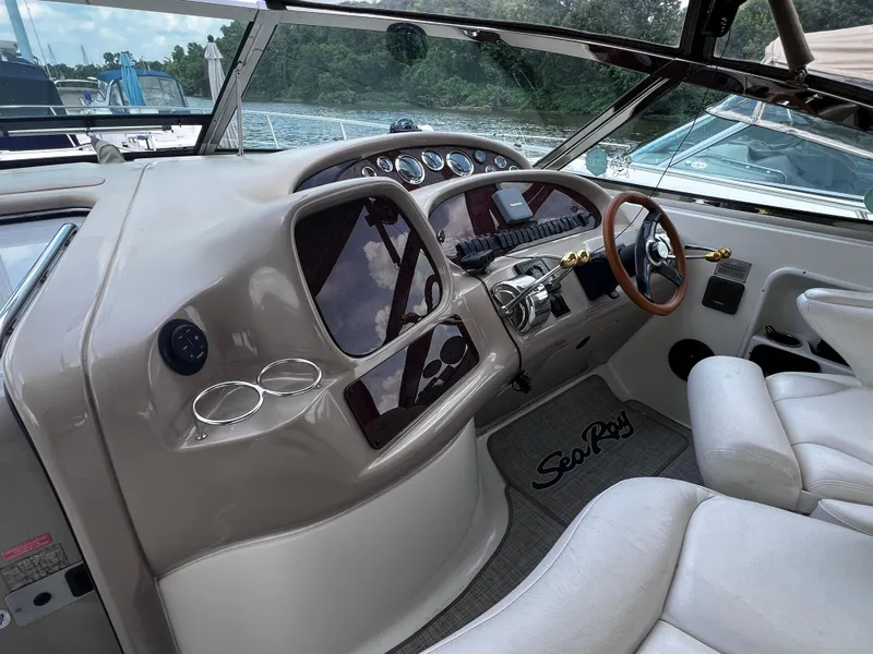 Slide: The Image of Cockpit of 2000 Sea Ray 380 Sundancer with steering wheel and control panel. - 12