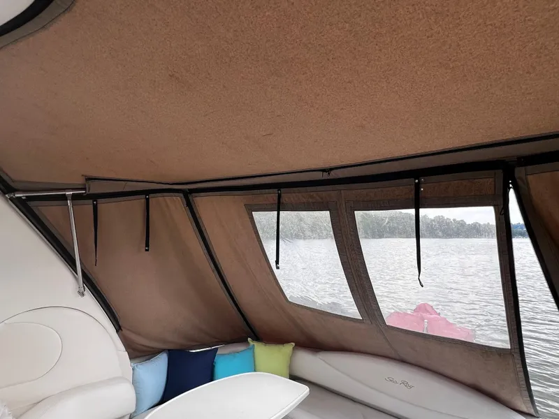 Slide: The Image of Interior view of 2000 Sea Ray 380 Sundancer with lake backdrop and colorful cushions. - 19