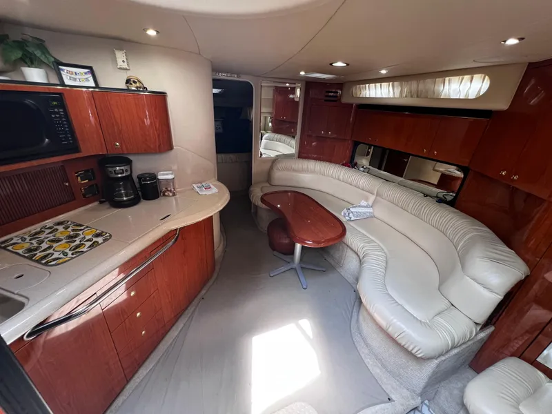 Slide: The Image of Interior of 2000 Sea Ray 380 Sundancer yacht with kitchen and seating area. - 20