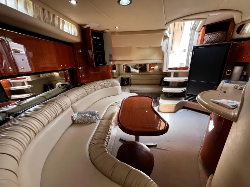 Slide: The Image of Luxurious interior of a 2000 Sea Ray 380 Sundancer yacht with elegant seating and wood finishes. - 21