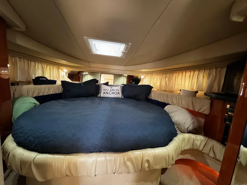 Slide: The Image of Luxurious interior of 2000 Sea Ray 380 Sundancer with cozy bedding and ambient lighting. - 28