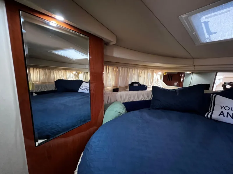 Slide: The Image of Interior cabin of 2000 Sea Ray 380 Sundancer with blue bedding and mirror. - 29