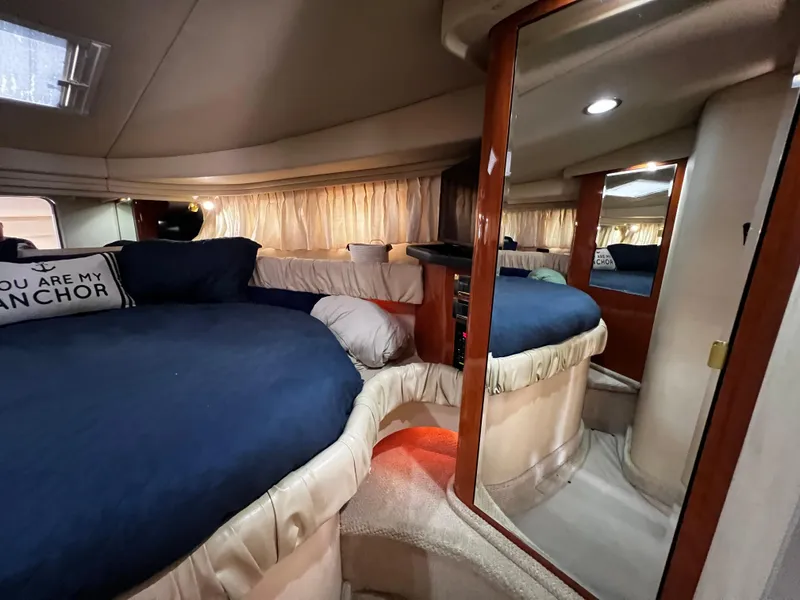 Slide: The Image of Interior cabin of 2000 Sea Ray 380 Sundancer with cozy bedding and mirror. - 30